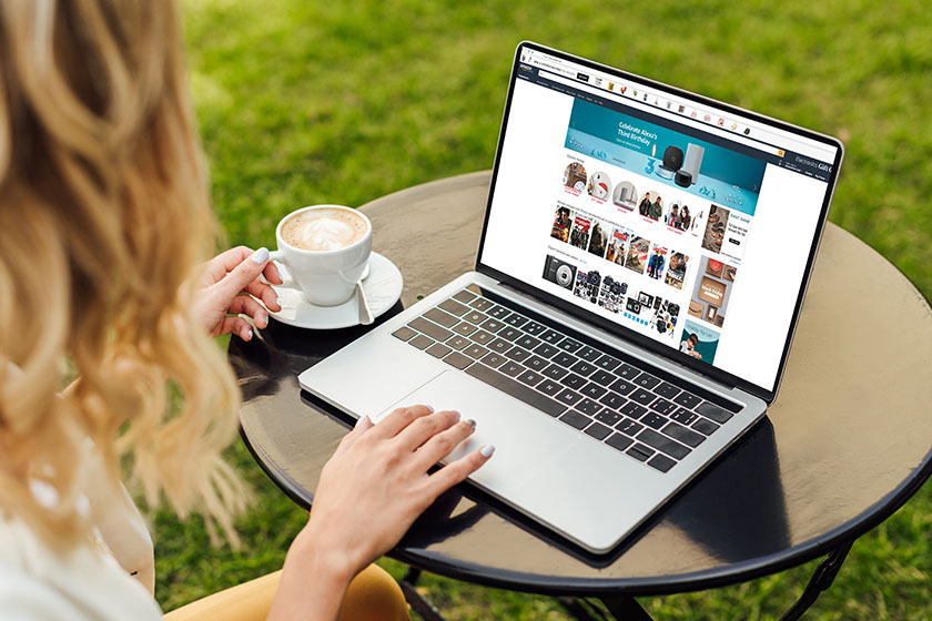 Cropped image of woman using laptop